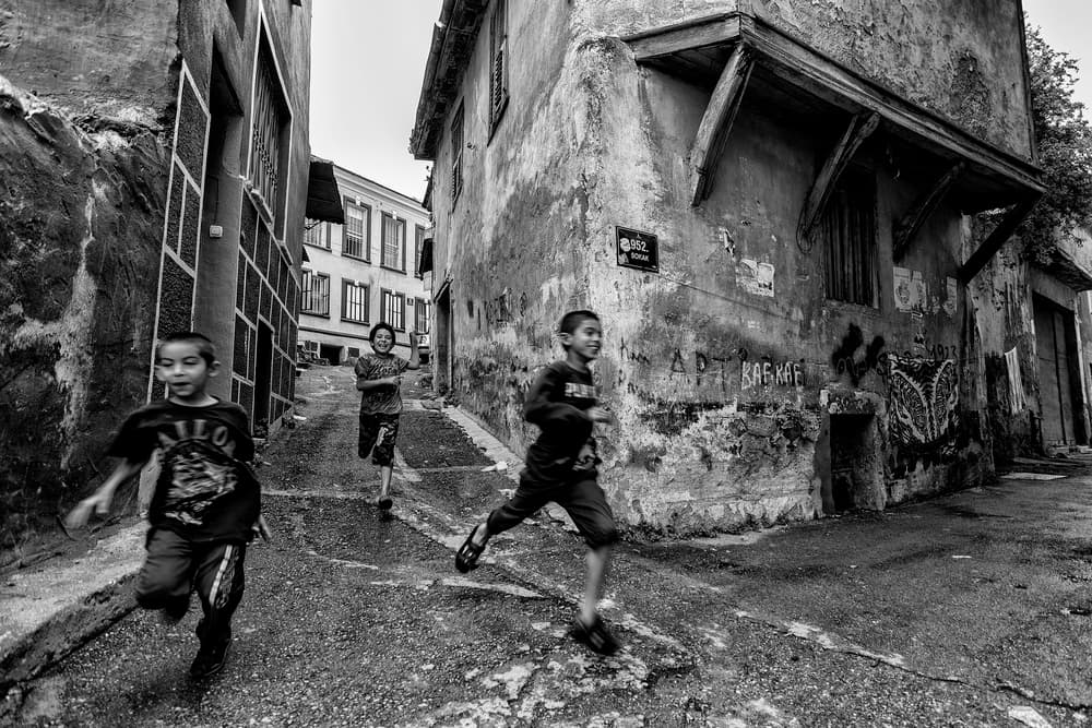 Boys Running City Alley by Yasemin Bakan — canvas wall art
