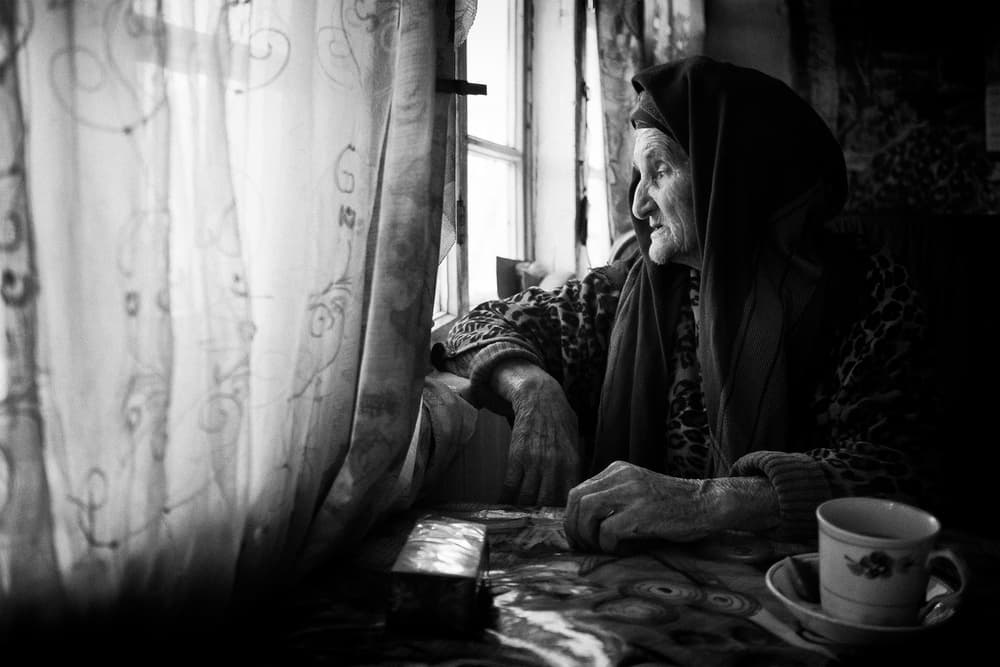 Elderly Woman's Pensive Gaze by Marcel Rebro — canvas wall art
