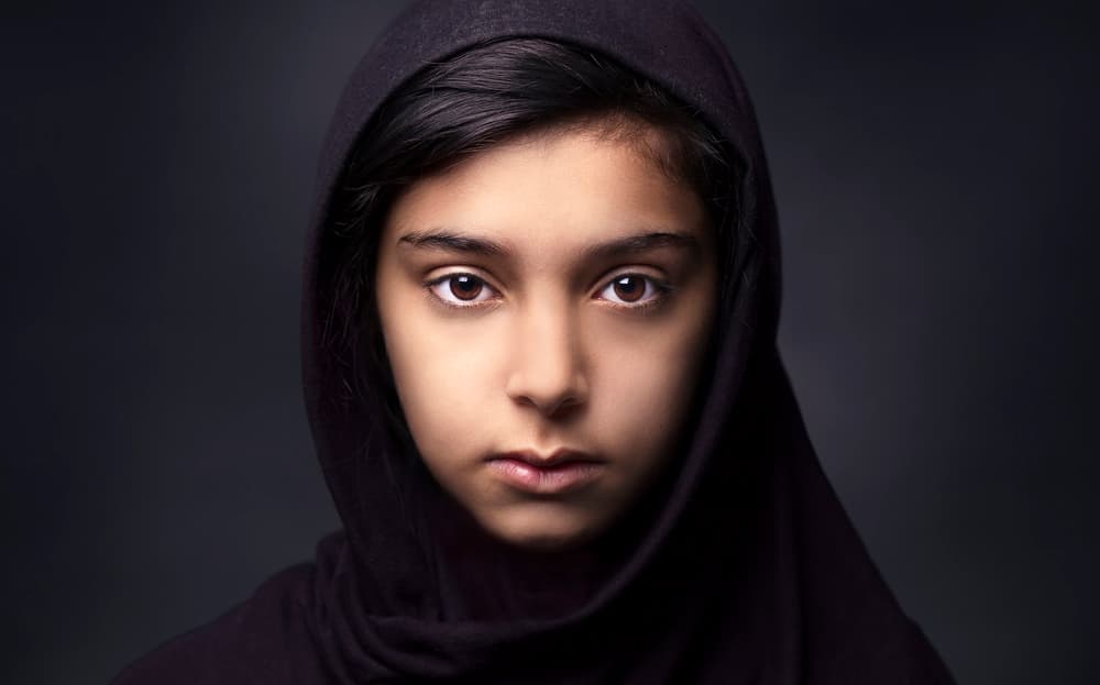 Hooded Girl Intense Gaze by Fadhel — canvas wall art