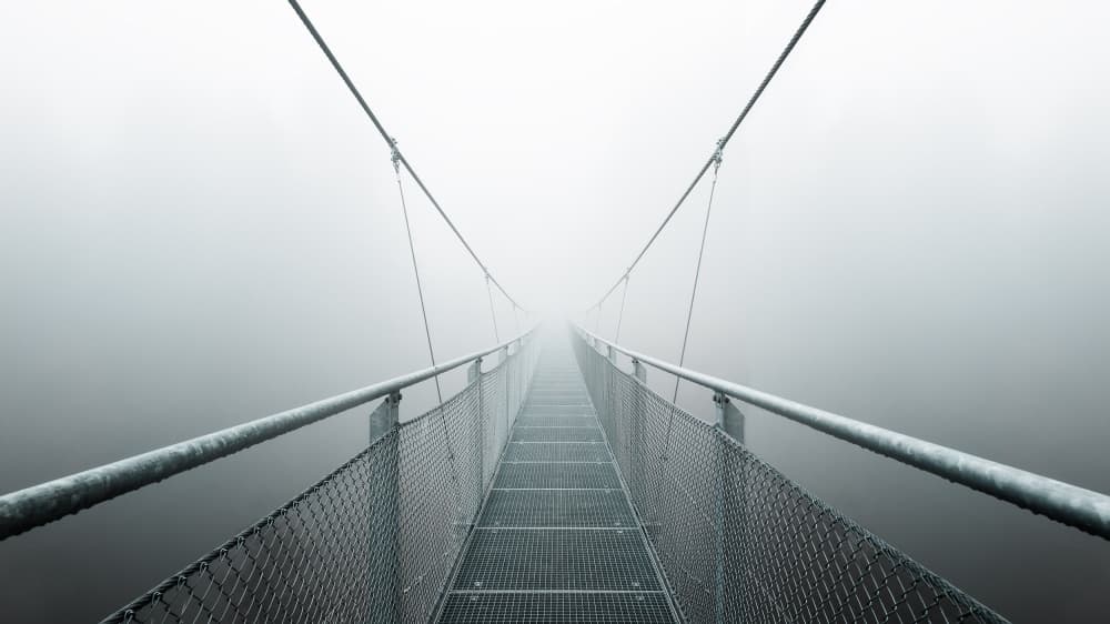 Misty Suspension Bridge by Max Zimmermann — canvas wall art