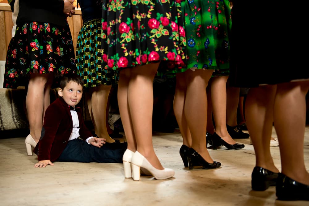 Playful Boy Among Legs by Vlad Dumitrescu — canvas wall art