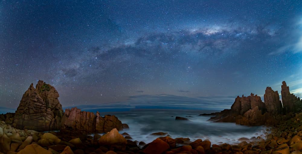 Starry Night Ocean Rocks by Zhaonian Zhou — canvas wall art