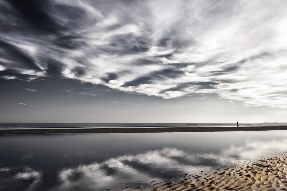 Lone Walker on Reflective Beach by Mitja Kobal — canvas wall art