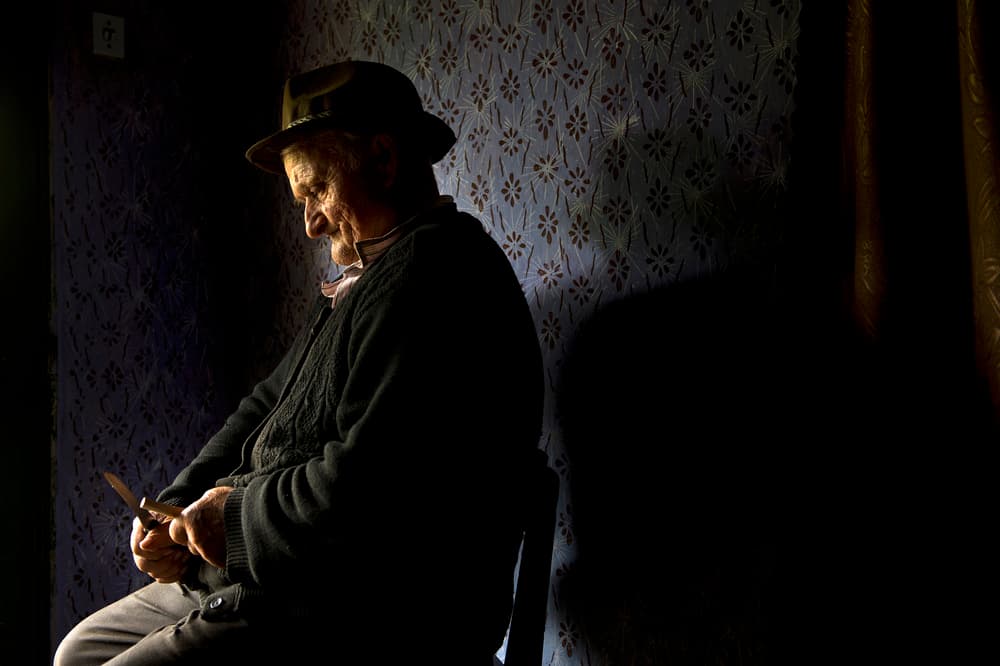 Elderly Man Sharpening Knife by Vlad Dumitrescu — canvas wall art